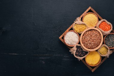 Tahıl ve tahıl ahşap arka plan üzerinde ahşap sepet içinde kümesi. Üstten Görünüm. Kopya alanı.