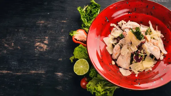 Sezar salatası tavuk fileto. Soğuk aperatifler. Siyah ahşap arka plan üzerinde. Kopya alanı.