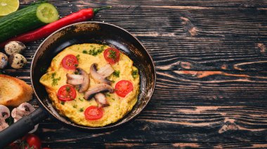 Mantar ve taze sebze ve fındık bir tavada omlet. Ahşap bir arka plan üzerinde. Üstten Görünüm. Kopya alanı.