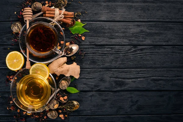 Black and green tea with lemon, honey, cinnamon and ginger. Hot drink Top view. Copy space.