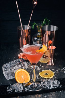 Alkol kokteyli Cosmopolitan. Siyah arka plan çubuğunda.