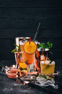 Narenciye alkollü kokteyl barda. Siyah bir ahşap arka plan üzerinde.
