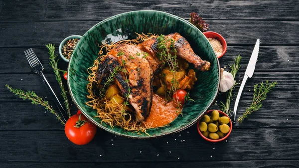 Grilled chicken cooked in a hoster. Meat. Top view. On a black wooden background. Copy space.