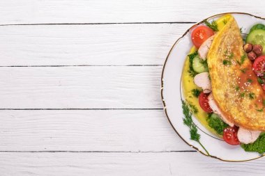 Omlet tavuk ve taze sebze ve fındık ile. Ahşap bir arka plan üzerinde. Üstten Görünüm. Kopya alanı.