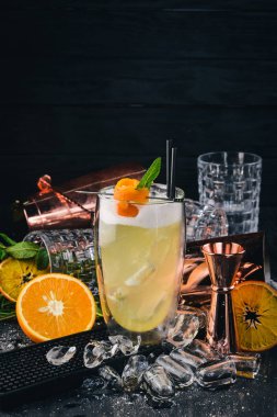 Alkol kokteyl Pinacolada. Orange, likör, buz. Siyah bir ahşap arka plan üzerinde.