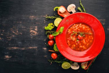 Mısır, tavuk ve biber domates çorbası. Üstten Görünüm. Siyah ahşap arka plan üzerinde. Kopya alanı.