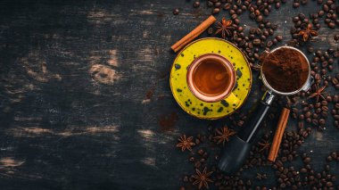 Bir fincan sıcak espresso kahve. Tarçın. Siyah ahşap arka plan üzerinde. Üstten Görünüm. Kopya alanı.