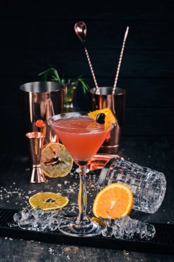 Alkol kokteyli Cosmopolitan. Siyah arka plan çubuğunda.