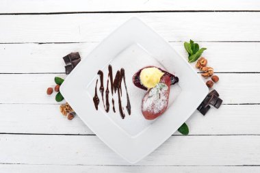 Tatlı. Karamelize armut bir plaka üzerinde dondurma ile. Ahşap bir arka plan üzerinde. Üstten Görünüm. Kopya alanı.