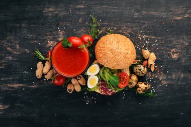 Kahvaltı. Domates suyu ve burger salam ve sebze. Ahşap bir arka plan üzerinde. Üstten Görünüm. Kopya alanı.