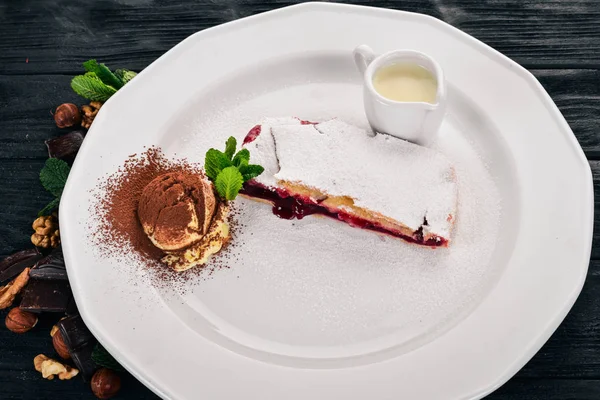 Tatlı. Strudel berry reçel ve bir plaka üzerinde dondurma ile. Ahşap bir arka plan üzerinde. Üstten Görünüm. Kopya alanı.