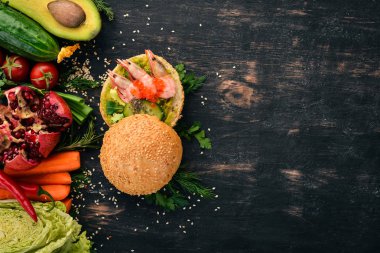 Burger, karides, avokado, havyar ve salatalık sandviç. Ahşap bir arka plan üzerinde. Üstten Görünüm. Kopya alanı.