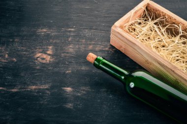 Bir kutu eski kırmızı şarap bir şişe. Siyah ahşap arka plan üzerinde. Üstten Görünüm. Metniniz için kopya alanı.