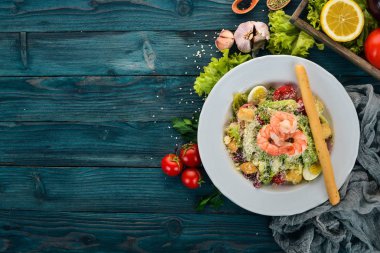 Sezar salata karides ile. Mavi ahşap arka plan üzerinde. Üstten Görünüm. Metniniz için kopya alanı.