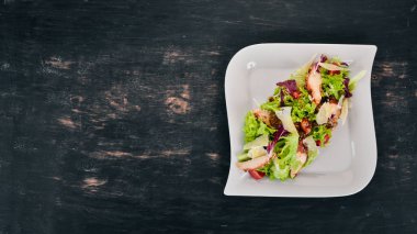 Sezar salata tavuk. Üstten Görünüm. Ahşap bir arka plan üzerinde. Kopya alanı.