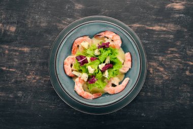 Kraliyet karides krem sos ve peynir. Bir plaka üzerinde deniz ürünleri. Üstten Görünüm. Siyah ahşap arka plan üzerinde. Kopya alanı.