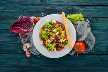 Peynir, fındık ve taze sebze salatası. Ahşap bir arka plan üzerinde. Üstten Görünüm. Metniniz için kopya alanı.