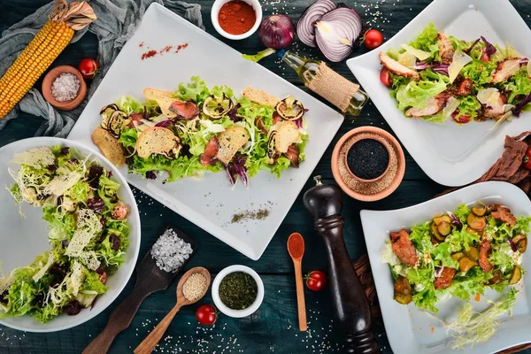 Een Aantal Salades Sla Zalm Kalfsvlees Bovenaanzicht Een Houten Achtergrond — Stockfoto