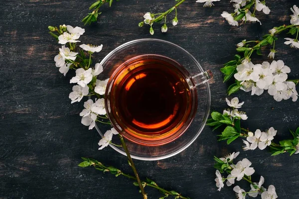 Herb tea with flowers. On a wooden background. Top view. Copy space.