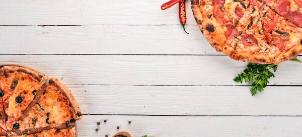 Set pizza. Italian cuisine. Top view. On a wooden background. Copy space.