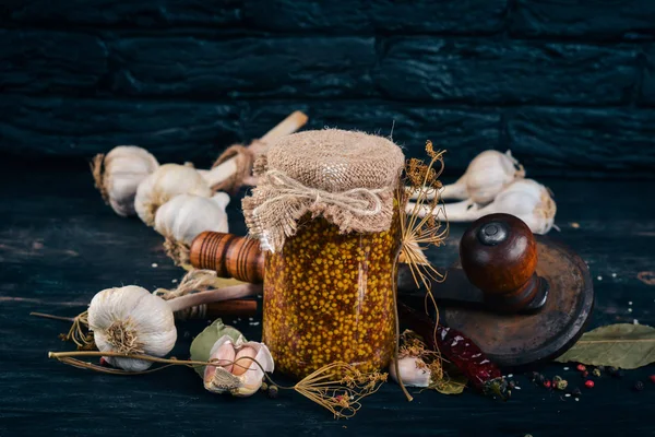 Pickled mustard in a jar. Stocks of food. Top view. On a wooden background. Copy space. — Stock Image Pickled Mustard Jar Stocks Food Top View Wooden Background Copy Royalty Free Stock Images