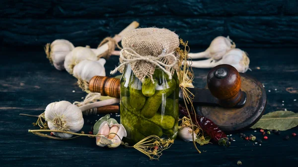 Pickled cucumbers in a jar. Stocks of food. Top view. On a wooden background. Copy space. — Stock Image Pickled Cucumbers Jar Stocks Food Top View Wooden Background Copy Stock Image