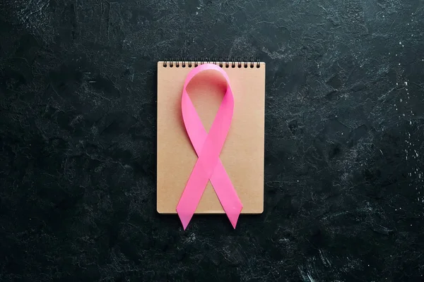 World cancer day: Breast Cancer Awareness Ribbon. Top view. Free copy space.