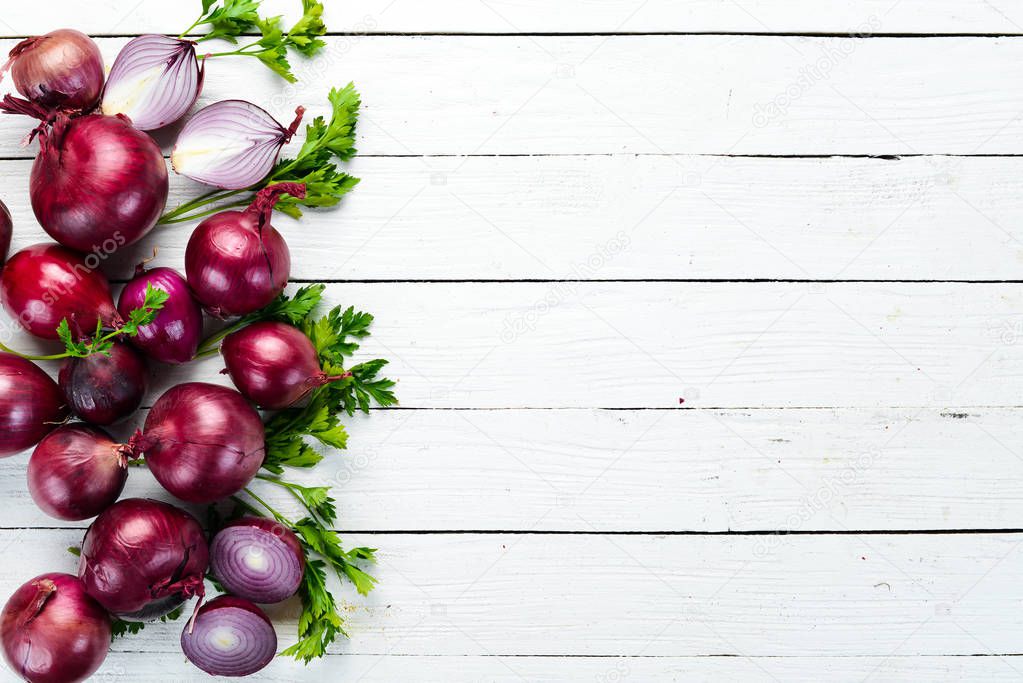 Purple fresh onion on white wooden background. Top view. Free copy space.