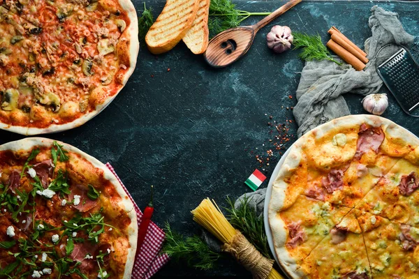 Pizza background. Assortment of pizza and ingredients. Italian traditional cuisine. Top view. Free copy space.