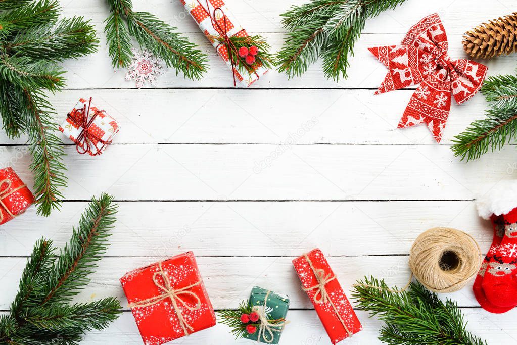 Christmas wooden white background with gifts and decorations. Top view.