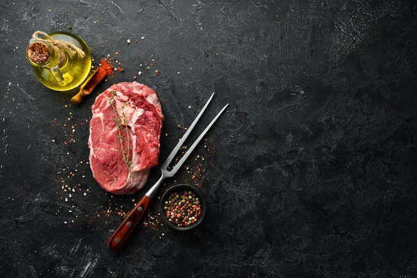 Raw Steak Ribeye Black Angus Fork Black Stone Background Top — Stock Photo, Image