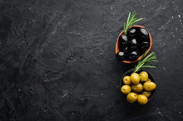 Colored olives in a bowl. Top view. Free space for your text.