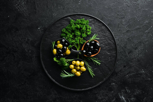 Colored olives in a bowl. Top view. Free space for your text.