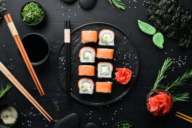 Somon ve avokadoyla Philadelphia suşisi rulosu. Geleneksel Japon Mutfağı. Üst Manzara. Kırsal biçim.