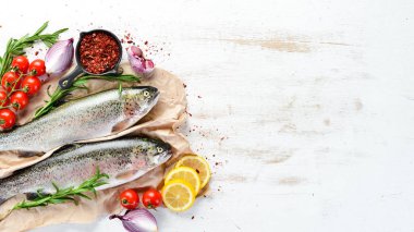 Beyaz ahşap arka planda çiğ balık. Balık alabalığı. Üst Manzara. Metnin için boş yer.