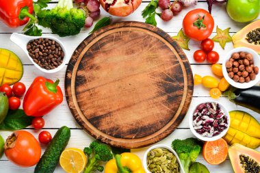 Vegetables, fruits, beans and nuts on a white background. Background Organic food. Top view. Free space for your text.