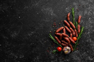 Smoked dry small salami sausages. Top view. Free space for your text.