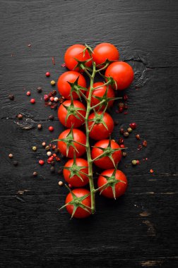 Fresh cherry tomatoes on a twig. In the old background. Top view. Free space for your text.