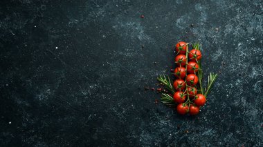 Fresh cherry tomatoes on a twig. In the old background. Top view. Free space for your text.