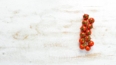 Fresh cherry tomatoes on a twig. In the old background. Top view. Free space for your text.