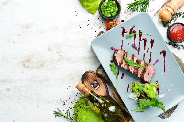 Beef steak with salad and sauce. Top view. Free space for your text.