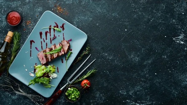 Beef steak with salad and sauce. Top view. Free space for your text.