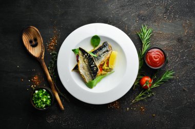 Baked mackerel fillet with vegetables. Top view. Free space for your text.