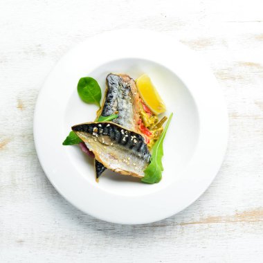 Baked mackerel fillet with vegetables. Top view. Free space for your text.