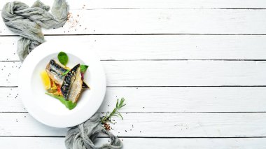 Baked mackerel fillet with vegetables. Top view. Free space for your text.