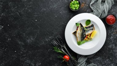 Baked mackerel fillet with vegetables. Top view. Free space for your text.