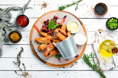 Snacks to beer on the board. Chicken wings, nuggets, sausages. Top view. Free space for your text.