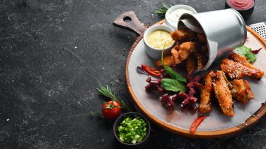 Snacks to beer on the board. Chicken wings, nuggets, sausages. Top view. Free space for your text.