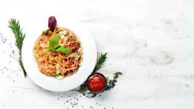 Pasta with tomatoes and vegetables. Carbonara. Italian cuisine. Top view. Free space for your text.