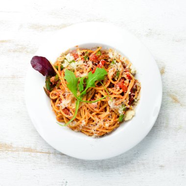 Pasta with tomatoes and vegetables. Carbonara. Italian cuisine. Top view. Free space for your text.